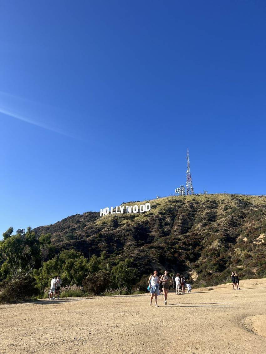 Hikers below the Hollywood Sign on the ridge above Beachwood Canyon