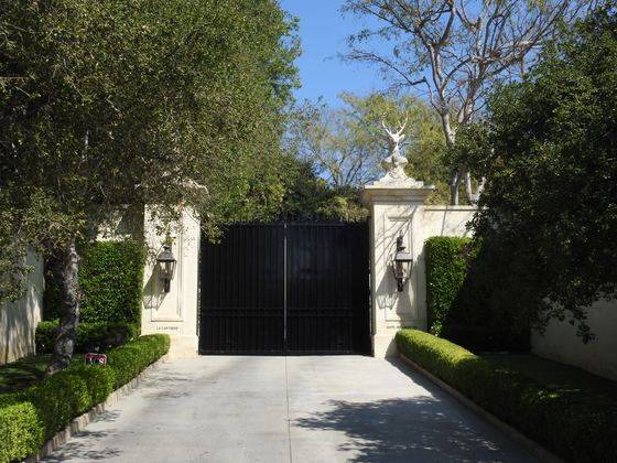 Estate gates and hedges on a Holmby Hills drive