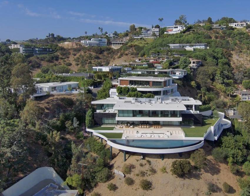 A contemporary estate with an infinity pool cantilevered over the hillside