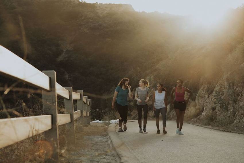 Hikers on a canyon trail at golden hour