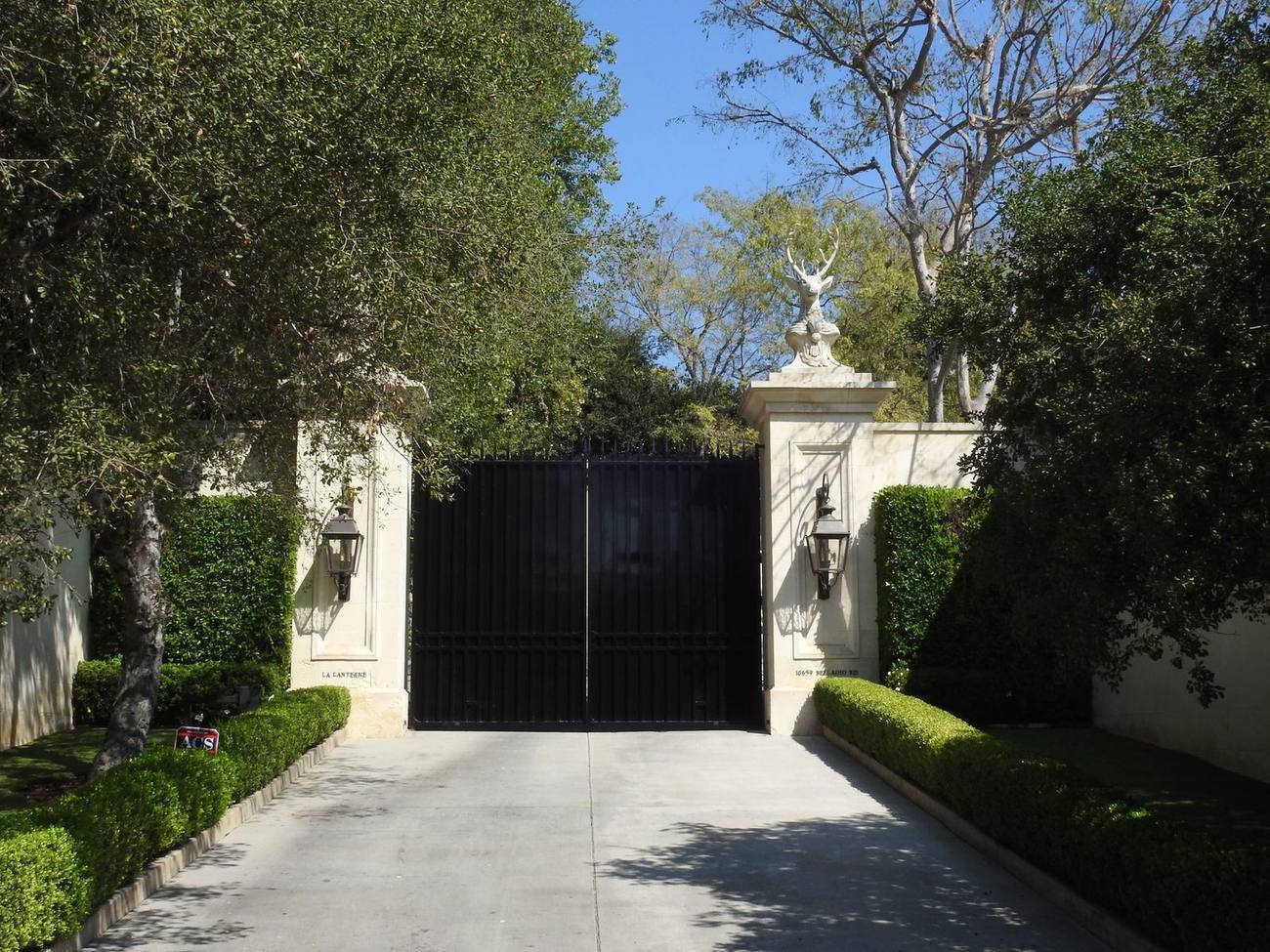Estate gates and hedges on a Holmby Hills drive