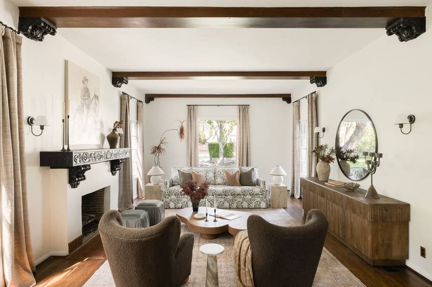 Living room with beamed ceiling and carved mantel at 146 S Martel