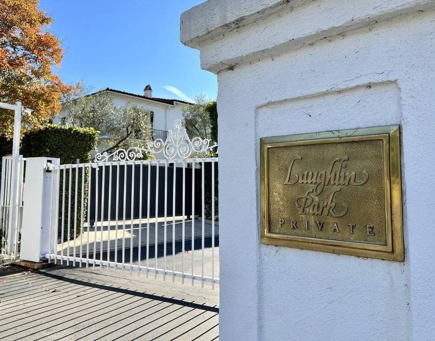 The gates and brass plaque at the entrance to Laughlin Park