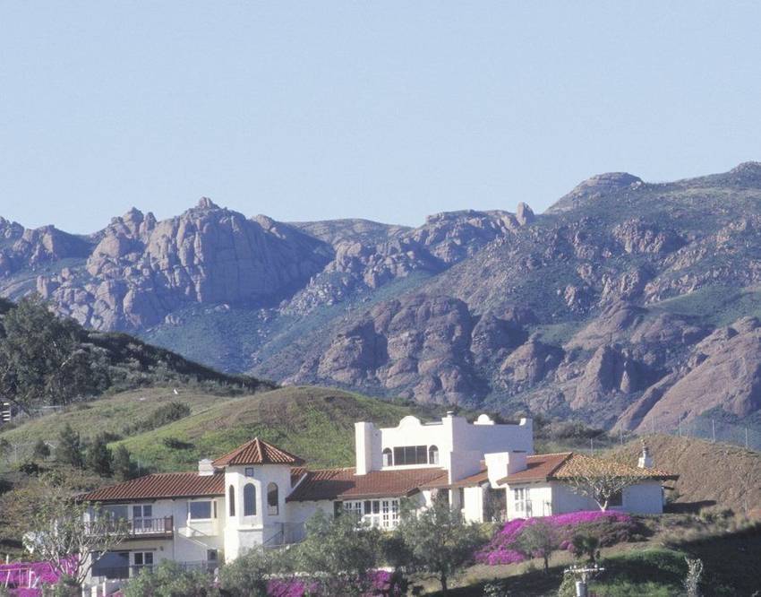A Mediterranean estate in the Malibu hills below the rock ridgeline