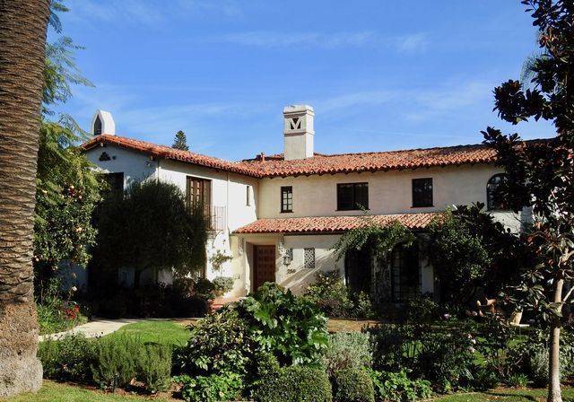 A traditional home behind hedges in Brentwood