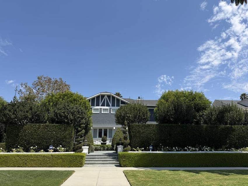 Shingled home behind clipped hedges in Windsor Square